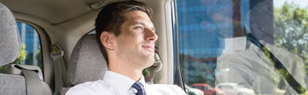 Elegant handsome man sitting comfortably in a taxicabの写真素材