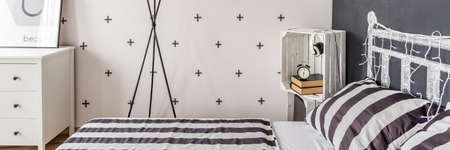 Decorative black and white wallpaper in little bedroomの写真素材