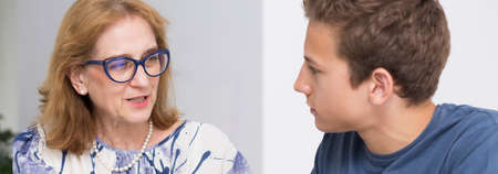 Closer shot of woman psychotherapist talking to her teenage patient