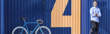 Handsome young man with bike in retro styleの写真素材