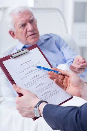 Shot of a senior man and his lawyer holding a last willの写真素材