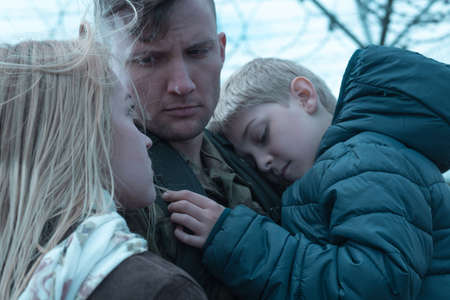 Close-up of a soldier's family holding each other and saying goodbyeの写真素材