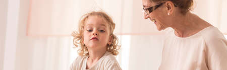 Grandmother looks with tenderness and joy to her grandsonの写真素材