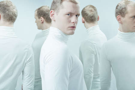 Young man with mental illness looking in front of himの写真素材