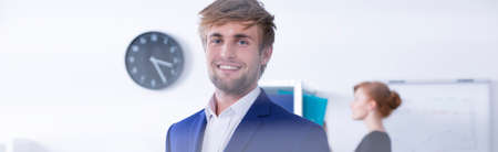 Smiling young businessman is looking directly with satisfactionの写真素材