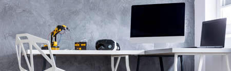 Panoramic view of a study room with crystal chair, desk, computer and decorative wall finish