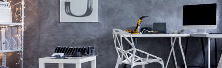Panoramic view of a home office with crystal chair, desk, computer and decorative wall finish