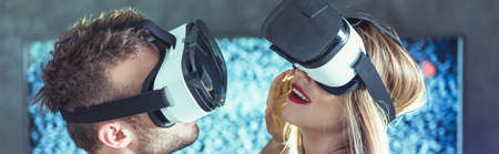 Man and woman in virtual goggles when having cybersexの写真素材