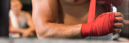 Close-up of boxer wrapping his hand whit tape before the fightの写真素材