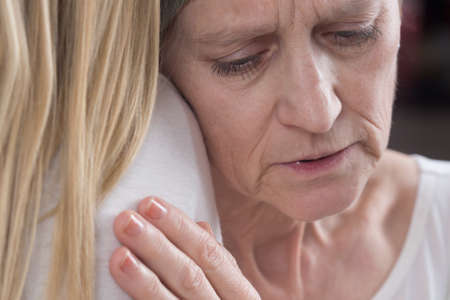 Cancer patient woman hugging her supporting daughter
