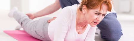 Shot of a suffering woman during a leg stretching