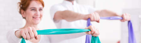 Shot of a smiling woman doing physical exercisesの写真素材