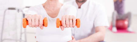 Cropped shot of a woman holding dumbbellsの写真素材