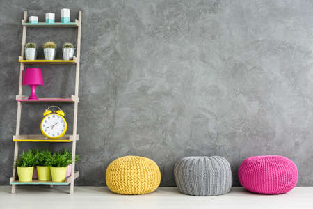 Grey home interior with three wool poufs and DIY regaleの写真素材