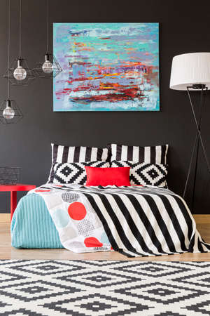 New bedroom with black wall, large bed and pattern detailsの写真素材