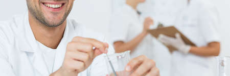 Young laboratory assistant preparing the substance for chemical researchの写真素材