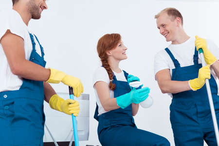Picture of happy professional office cleaners having break at workの写真素材