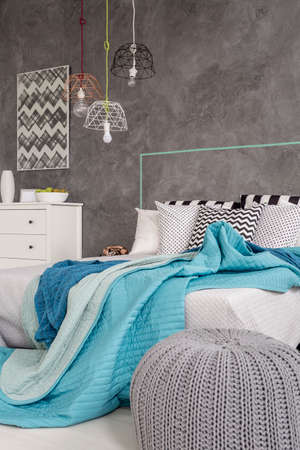 Shot of a comfortable interior with stylish pendant lamp hanging above the bed