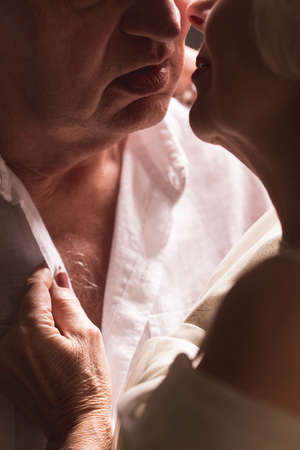 Close-up of sexy senior couple kissing tenderlyの写真素材