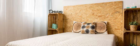 Fibreboard bed headrest in creative DIY bedroom interiorの写真素材
