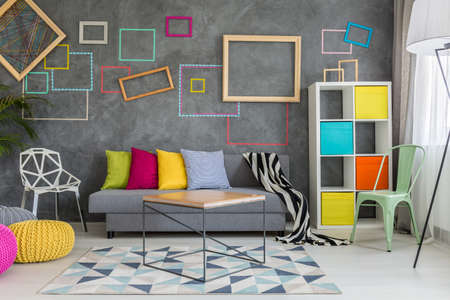 Spacious apartment in grey with colorful wall decor and sofaの写真素材