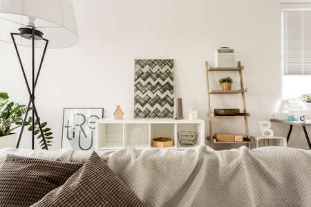 Modern open plan house in white with sofa and lampの写真素材