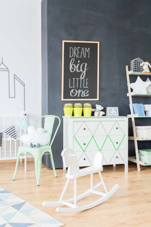 Cropped shot of a white rocking horse and a furniture set in a child's room interiorの写真素材