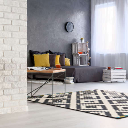 Squared picture of black and white bedroom interior