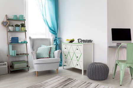 Shot of a bright woman's room interior with a minimalist workplace