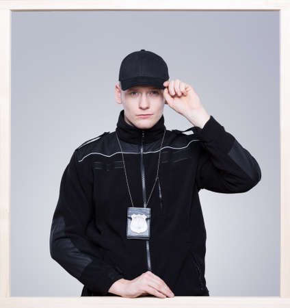 Policeman in uniform, with the badge and cap