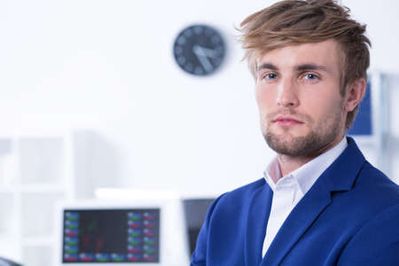 Closer shot of elegant young man standing at modern officeの写真素材