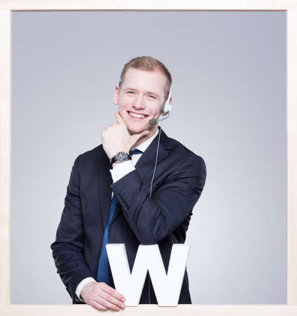 Smiled and elegant businessman using a headset during workの写真素材