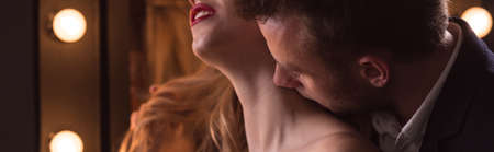 Young man is kissing his lover's neckの写真素材