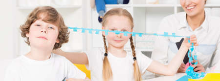 Small girl at school holding a pepercutの写真素材