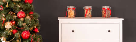 Room with commode and tree decorated for Christmas timeの写真素材