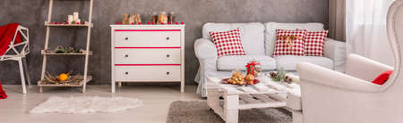 Well-lighted room with commode, couch and Christmassy motivesの写真素材