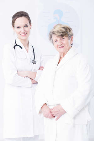 Shot of elder woman and young doctor standing close each otherの写真素材