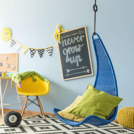 Shot of a colorful children's room with a hanging chairの写真素材