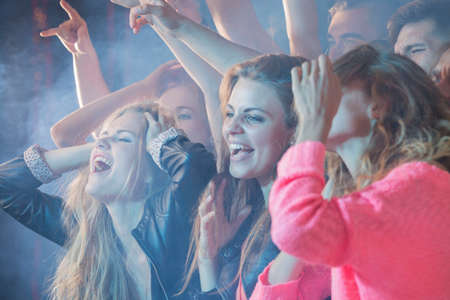 Crowd of people having fun at a concert show