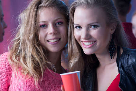 Two young friends having fun during party