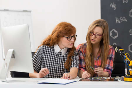 Shot of two focused geek students in a classroom, discussing the resultsの写真素材
