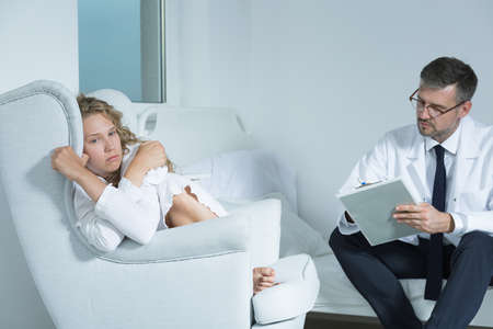 Young woman on a session with a psychiatristの写真素材