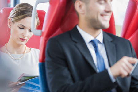 Elegant man and woman commuting by tram