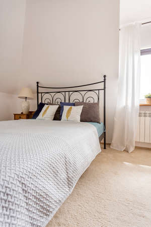 Shot of a bed in a stylish white bedroom
