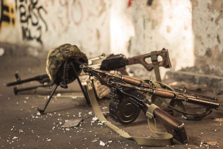 Military automatic guns and helmets on firing rangeの写真素材