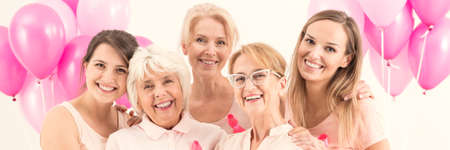 Group of women with pink balloons during anti-cancer campaign