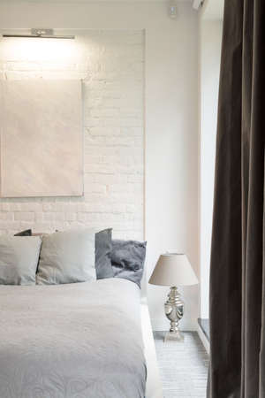 Large bedroom in bright colors with a comfortable double bed