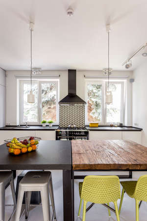 Modern and light kitchen with two different tablesの写真素材