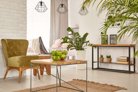 Multifunctional interior with bed, table and armchair