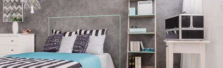 Modern bedroom with concrete wall, table and double bedの写真素材